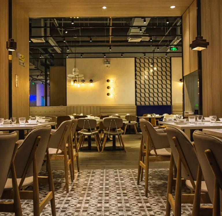 Elegant cafe interior in Dubai designed by Rawabi, featuring plush seating and modern decor.