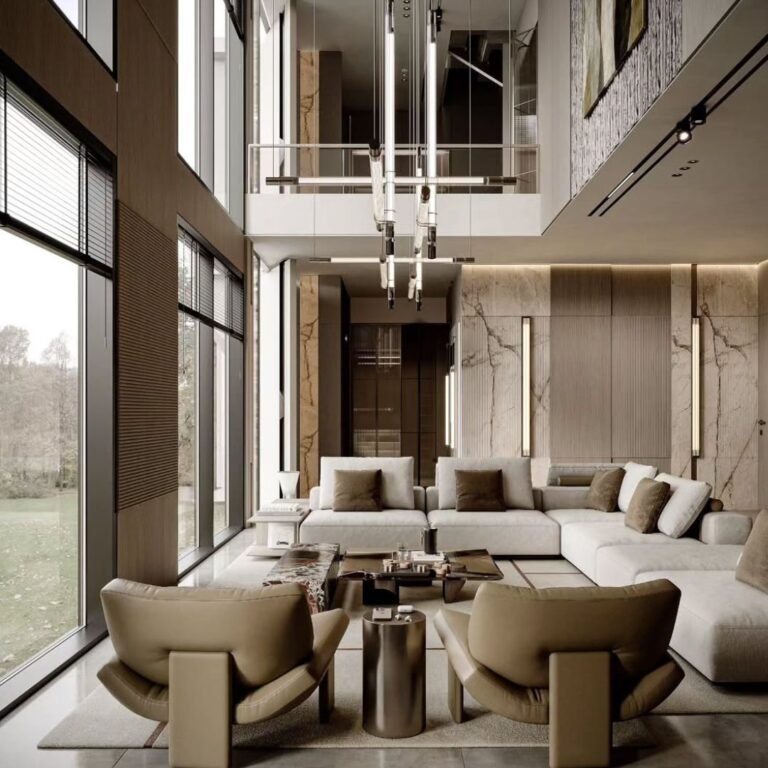 A luxury villa designed with wide, open living spaces and soft natural tones. Large windows bring sunlight across marble and wood finishes, while the clean layout creates a balance of elegance and comfort. Perfect inspiration for modern villa interiors in Dubai — where grand design meets calm living.